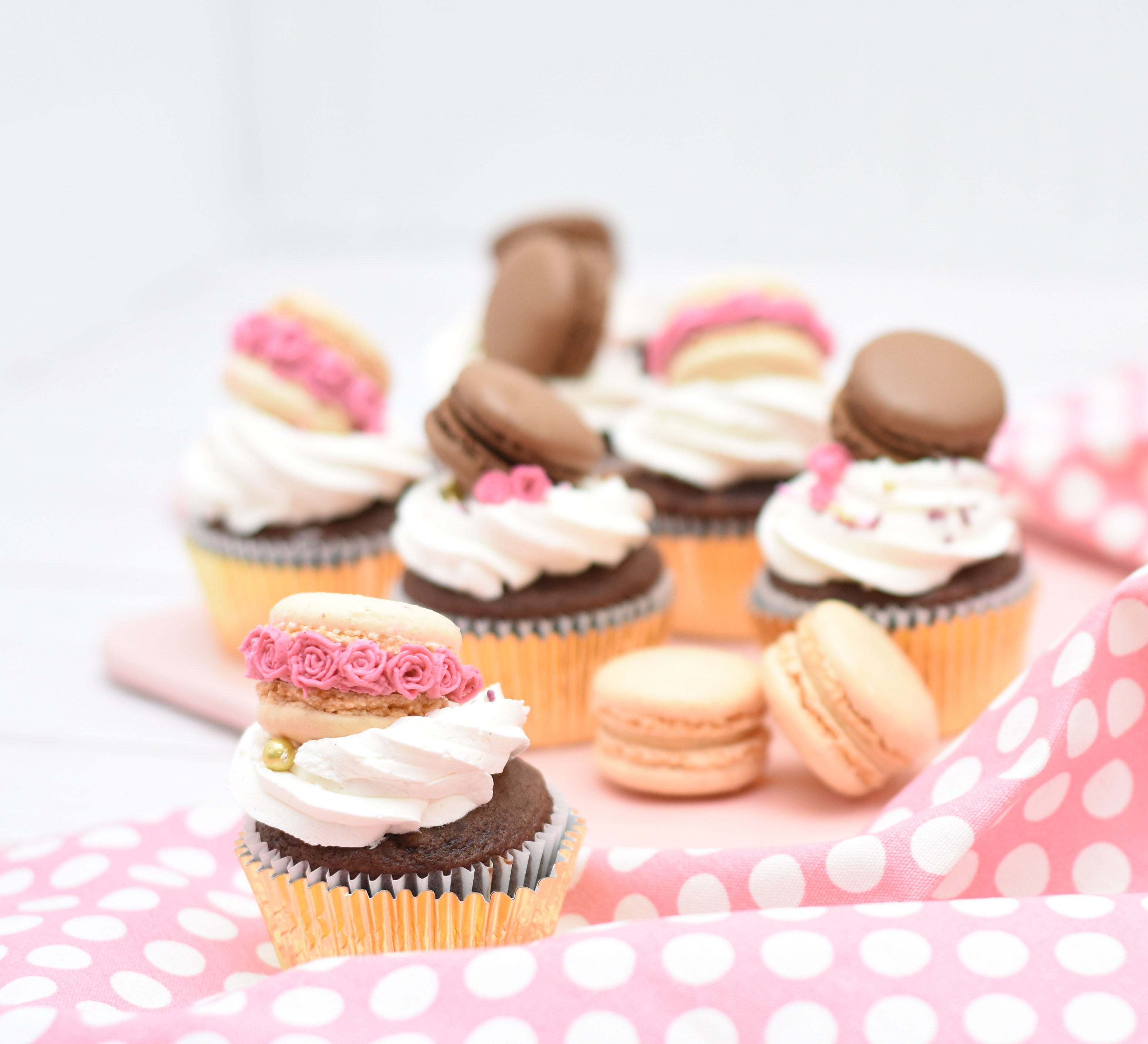 White cake cupcakes with white frosting and sprinkles